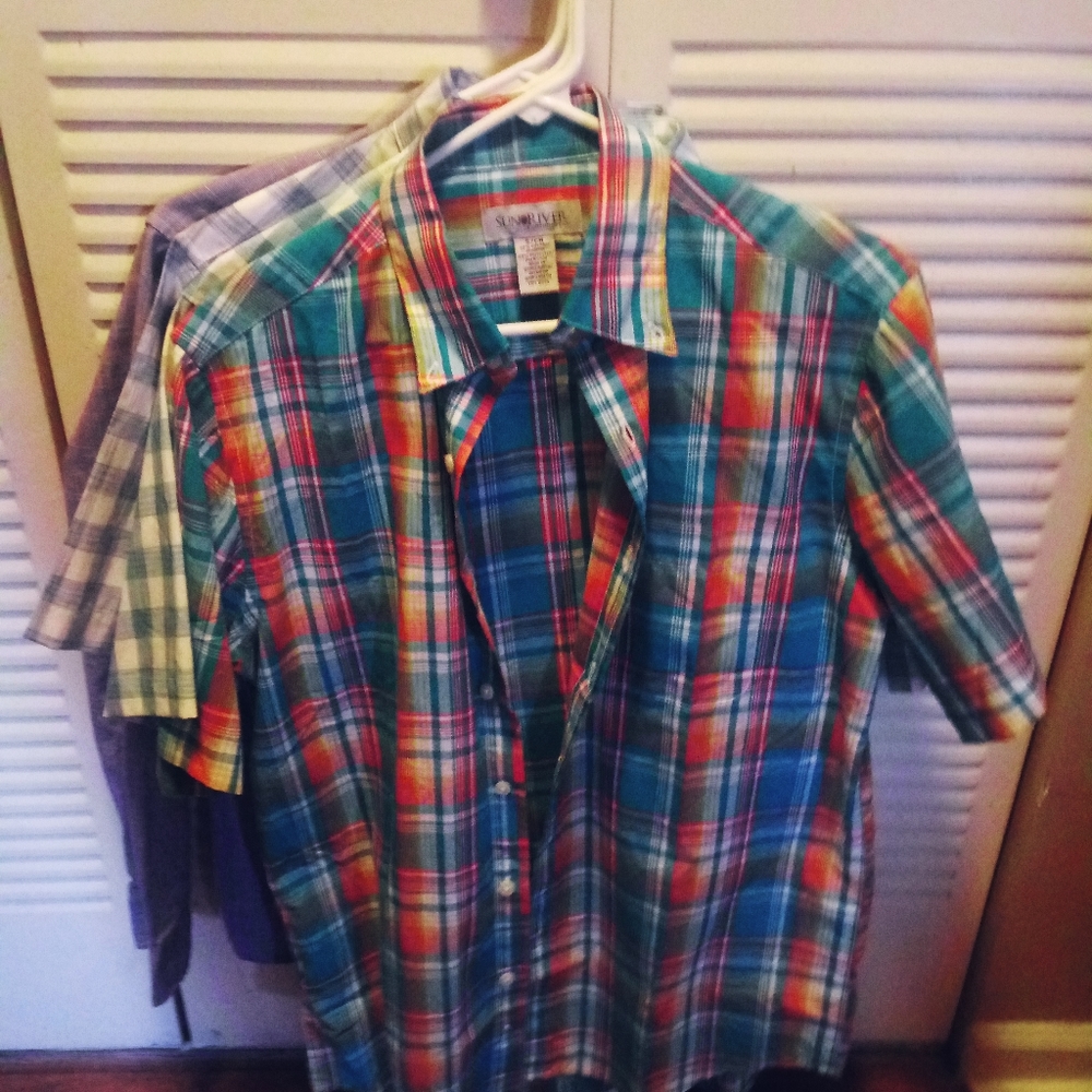 A bunch of collared dress shirts